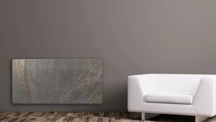 Climastar smart stone heater beside a modern white armchair
